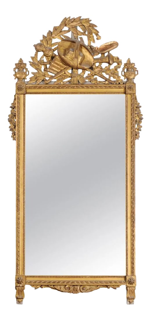 Late 18th Century Louis XVI French Period Giltwood Mirror: A French Louis XVI period giltwood mirror from the late 18th century, with carved crest. Born in France during the later years of King Louis XVI reign, this exquisite wall mirror captures our