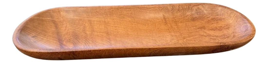 Andrianna Shamaris Oval Teak Wood Platter: Minimalist shallow platter hand carved from a single piece of aged teak wood and finished with a natural oil revealing the beautiful wood grain. Own an Andrianna Shamaris original. Andrianna