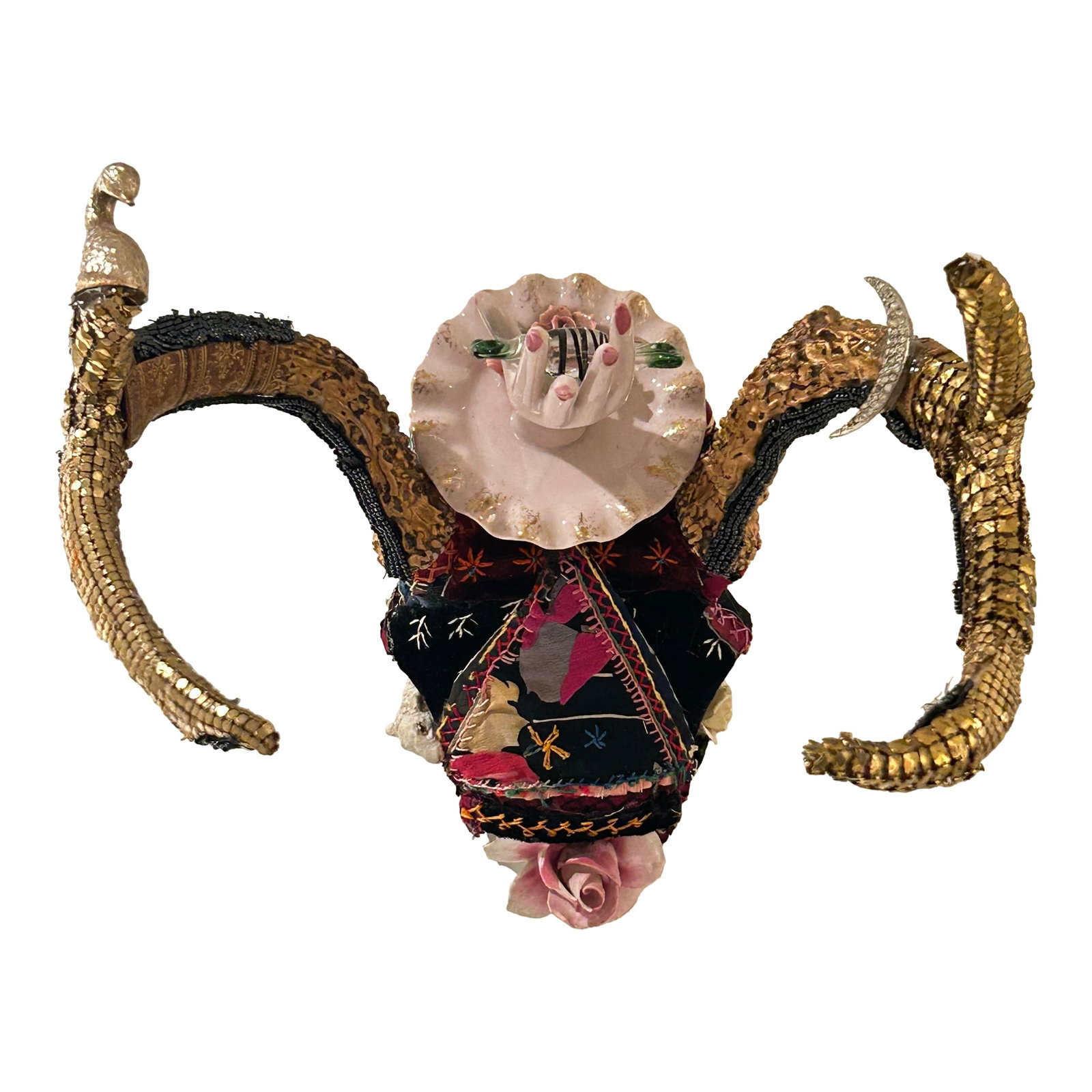 Mixed Media Skull Wall Sculpture Titled Giving Sweet: Delightful mixed media skull wall sculpture titled "Giving Sweet", having a mix of crazy quilt, gold lame bits and pieces, porcelain ring holder hand holding blown glass candy in a gesture of giving.