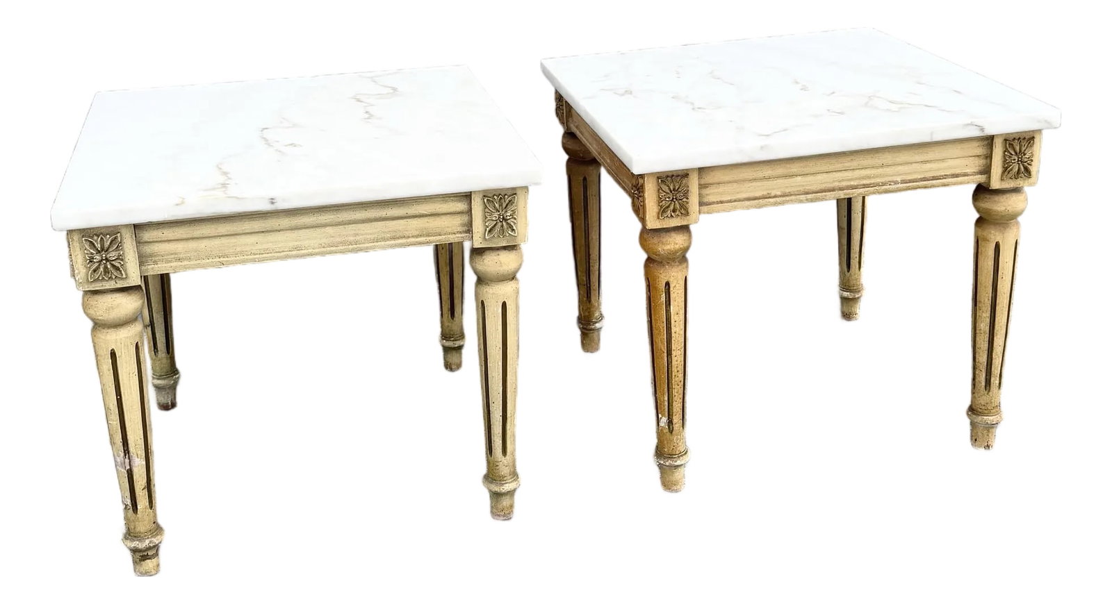 Neoclassical Portuguese Marble Top Wooden Side Tables - A Pair: An elegant pair of neoclassical side tables, featuring solid wooden frames topped with refined marble surfaces. The bases are richly detailed with carved rosettes and fluted, tapered legs, evoking