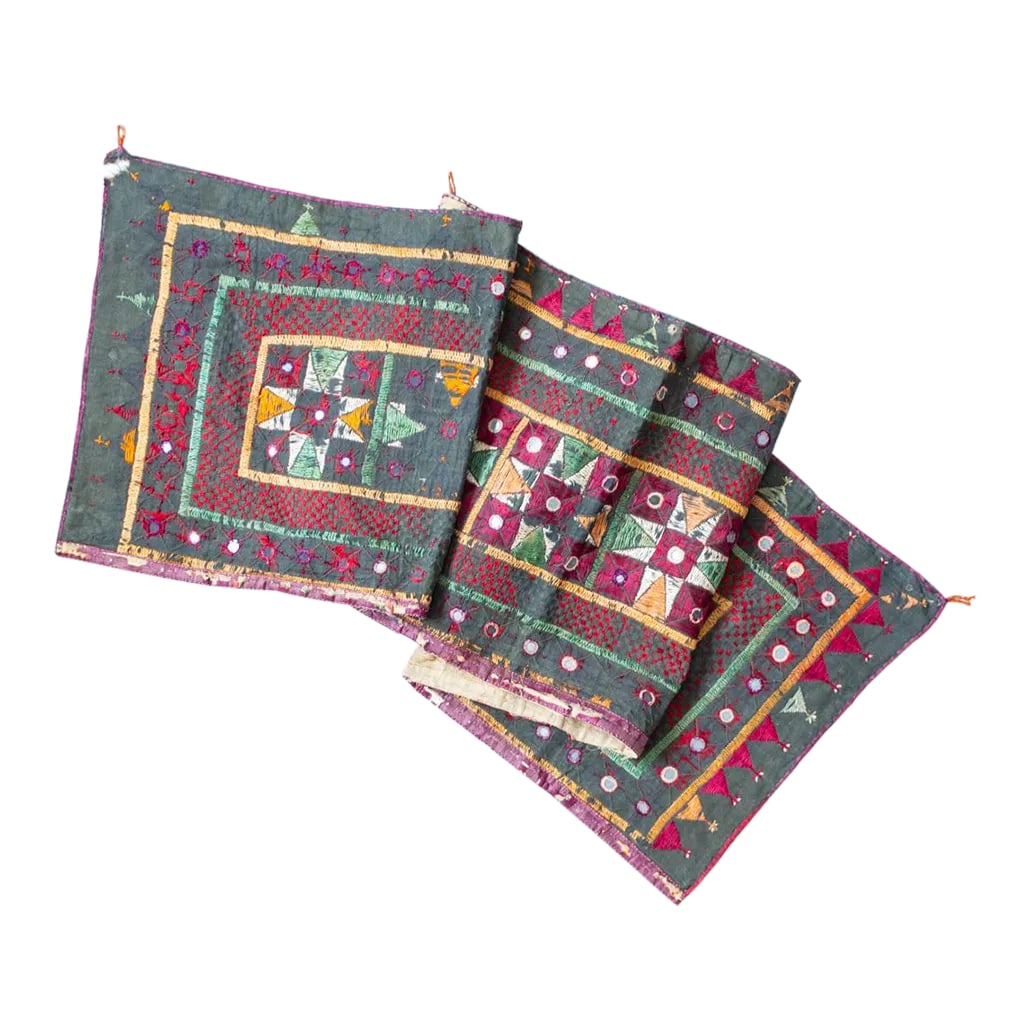 Vintage Indian Toran Embroidered Textile With Mirrors: This embroidered vintage Gujarat toran door banner from India features a repeating geometric pattern of finely embroidered silk in a combination of soft, muted earthy colors and a rich, ruby red typic
