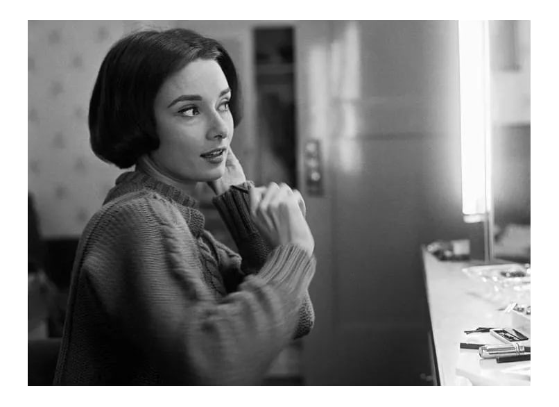 Audrey Hepburn at Her Dressing Room Mirror 1957 Photograph: Audrey Hepburn at her dressing room mirror, 1957. 11" x 14" silver gelatin fiber based print signed on verso by the photographer, Sid Avery. Edition #07 out of 70. This is an unframed print.
