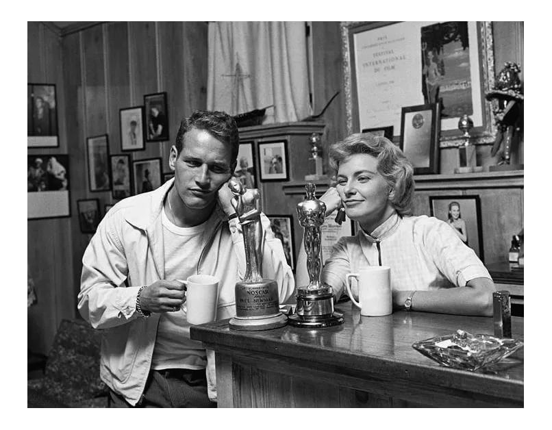 Paul Newman and Joanne Woodward 1958 (Photo by Sid Avery): Paul Newman and wife Joanne Woodward "admiring" their awards. His: Noscar for not having received an Oscar (yet) and Hers: for "The Three Faces of Eve," 1958. 11" x 14" silver gelatin print signed on