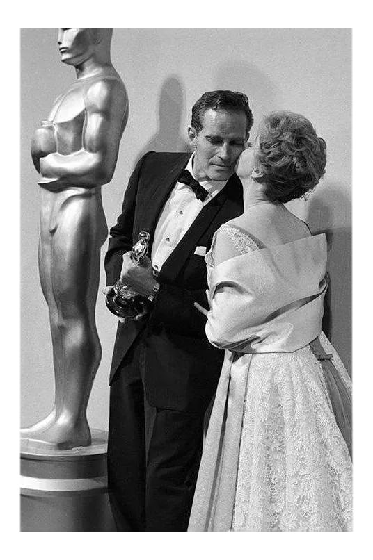 Charlton Heston and Susan Hayward at "The 32nd Annual Academy Awards" 1960: Charlton Heston and Susan Hayward at "The 32nd Annual Academy Awards," 1960. 11" x 14" silver gelatin print. Signed on recto by photographer Bernie Abramson. Edition #03 of an open edition.