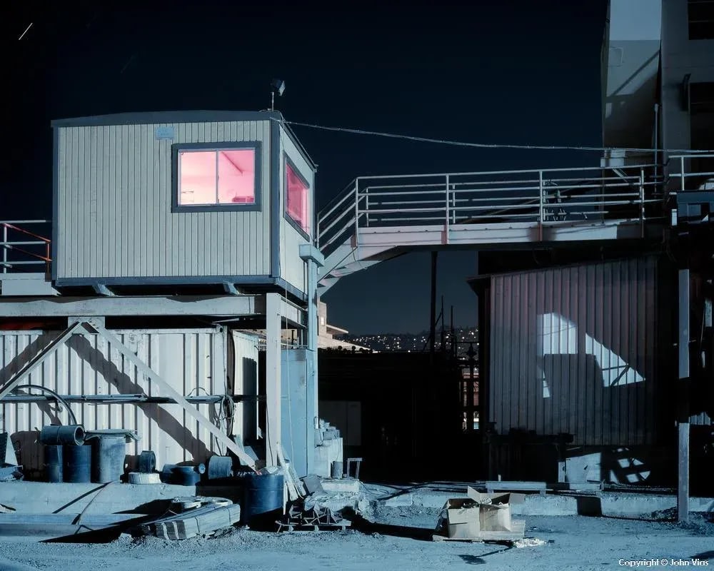Contemporary Night Photograph "Pink Room" by John Vias: Note from the artist, John Vias: "One of my favorite images because of the unexpectedness of finding a pink room in a concrete depot. That is a star trail in the upper left." This 11" x 14" archival