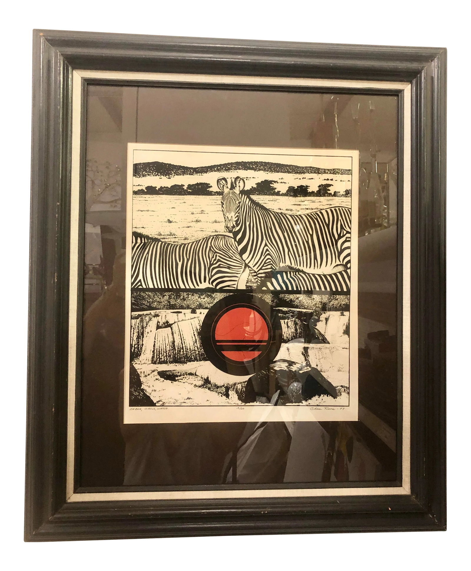 "Zebra, Circle, Water" Vintage 1970s Framed Print: Large, framed print of zebra entitled "Zebra, Circle, Water." Signed and dated 1977. Black wood frame, glass front. Red circle, zebras on a black and white background. Condition: Alterations: