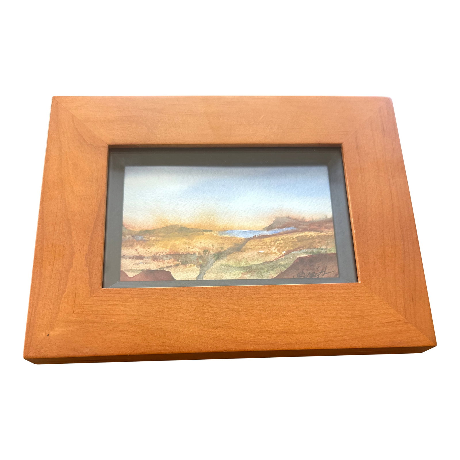 "Desert Vista" Framed Signed Original Watercolor Landscape: This framed watercolor landscape evokes the quiet majesty of a desert horizon. Warm earthy tones blend with distant blues and purples, capturing a sense of space and serenity. The painting is