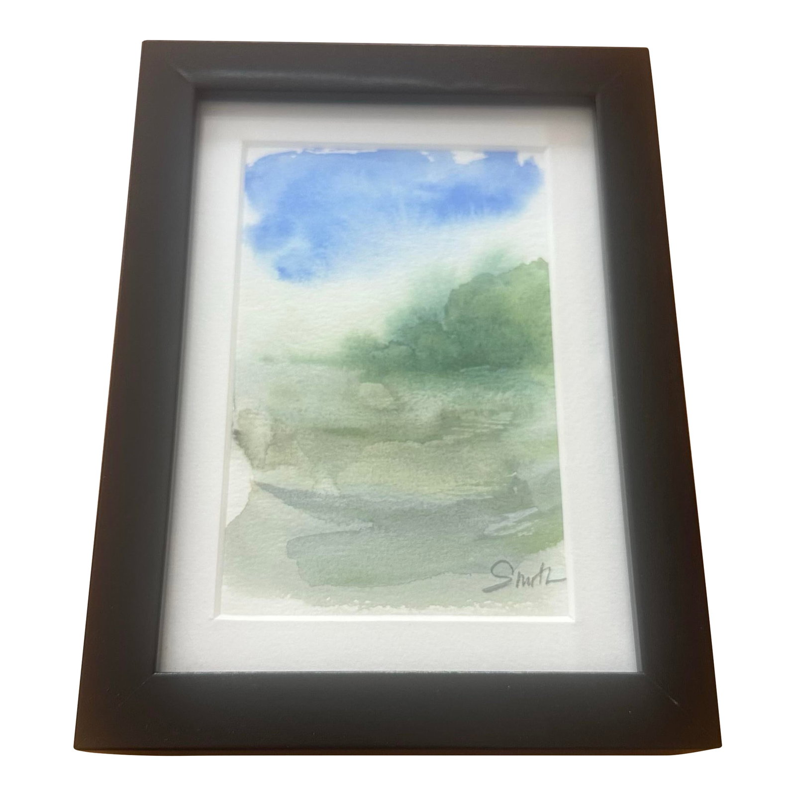 "Morning Fog" Framed Signed Original Watercolor by Nancy Smith: Original watercolor with an atmospheric, minimalist landscape composition. Layers of soft greens and blues suggest mist-covered hills under an open sky. The loose, fluid technique emphasizes calm and 