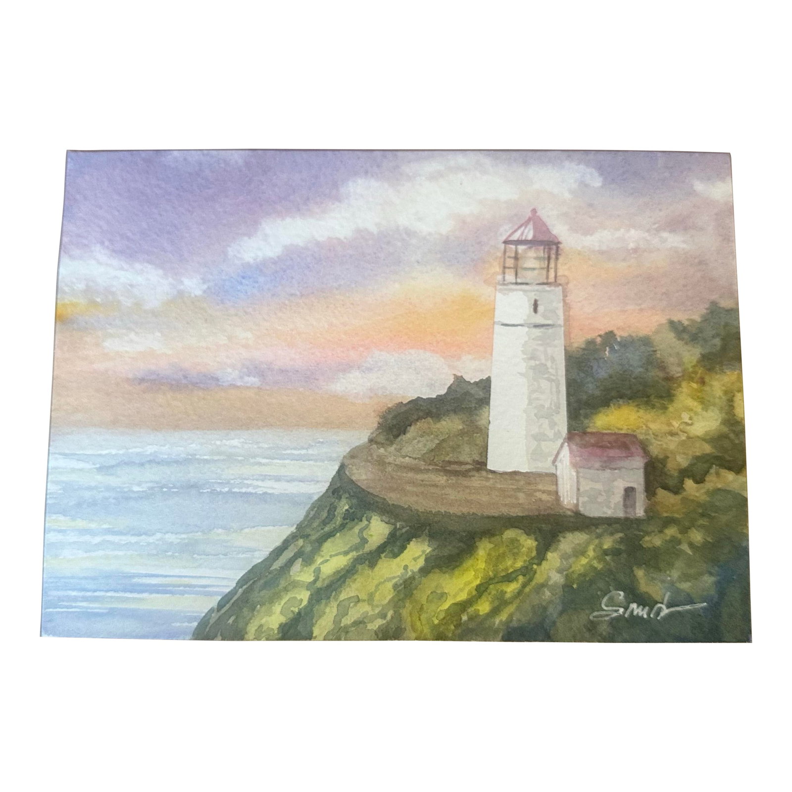 "Guiding Light" Signed Original Watercolor Painting by Nancy Smith: Original artwork, one of a kind. Signed by the artist. A peaceful coastal scene featuring a lighthouse perched above the sea, bathed in warm sunset hues. Soft purples, peach tones, and gentle blues bl