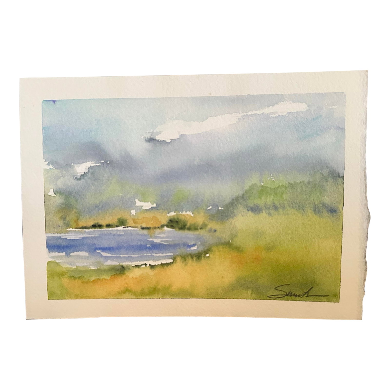 "Lakeside Serenity" Signed Original Watercolor Landscape by Nancy Smith: This gentle watercolor landscape depicts a quiet lakeside scene under a soft, cloud-streaked sky. The loose brushwork and subtle blending of greens and blues create a peaceful, impressionistic view