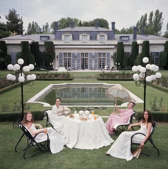 The Romanones by Slim Aarons 30x30 Framed C-Print: "The Romanones" by Slim Aarons 30x30 inches Framed Getty Images C-print. Whitewood gallery frame and matting. Dowager Countess of Romanones, Blanca de Borbon (right, with Parasol), with her daughter,