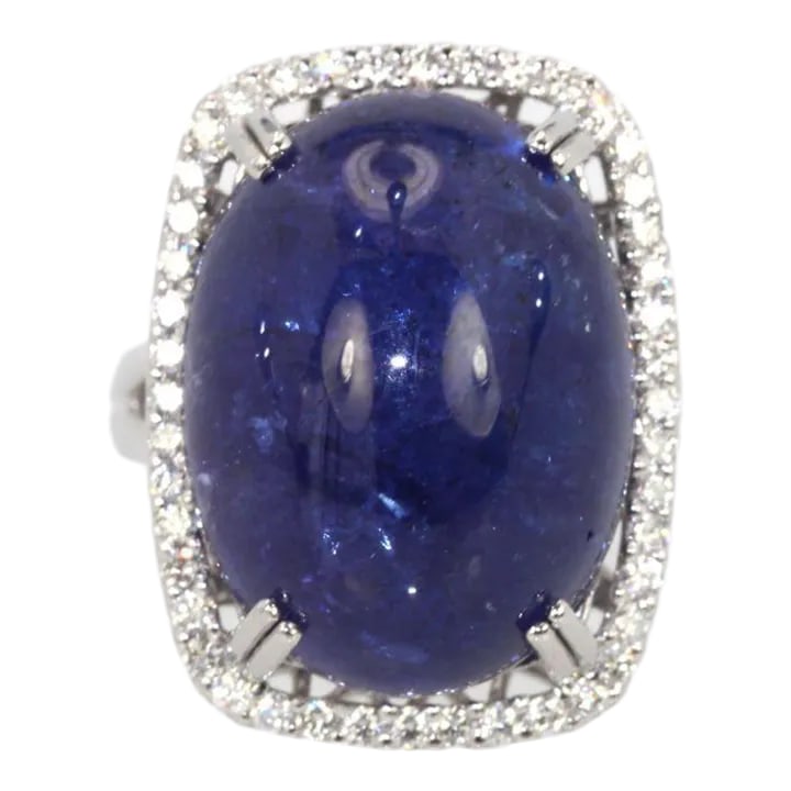 Tanzanite 35.39 Ct Cabochon High Dome Ladies Ring Size 6.5: This is part of Chairish's Fine Jewelry assortment. WEIGHT: 19.80 grams MAIN STONE: Tanzanite OTHER STONES: Diamonds, 1.25 carats, VVS-SSI clarity, G-H color METAL: 18k white gold SIZE: 6.5