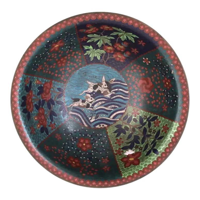 Antique Early Meiji Japanese Cloisonne Enamel Bowl With Rabbits in Waves: An antique Japanese, Meiji period, footed enamel over copper bowl. The interior of the bowl is adorned with polychrome enamel panels depicting blossoming flowers surrounded by a swirl motif, and a