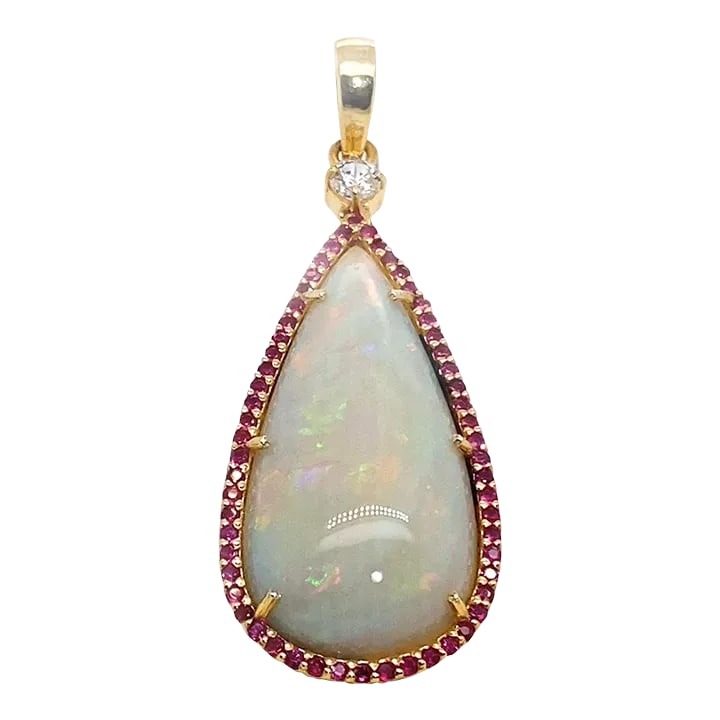 AJD Pendant Teardrop Opal Red & Green Surrounded by Ruby: This is part of Chairish's Fine Jewelry assortment. Magnificent 16.98ct Opal Pendant with Red and Green Flashes – Surrounded by Rubies and Zircon This stunning 16.98ct Opal pendant is a true