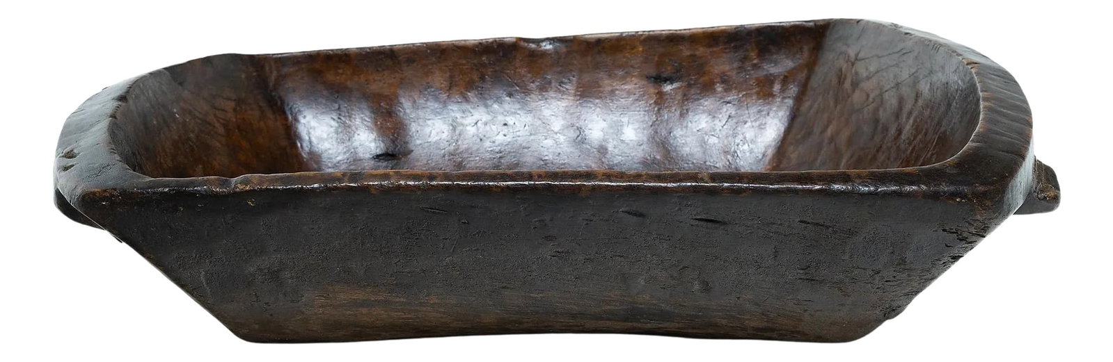 Large Provincial Chinese Farm Tray, circa 1900: This early-20th century wooden tray from northern China charms with rustic texture and asymmetric form. Hand-carved from a single block of wood, the tray has a rectangular shape with rounded corners