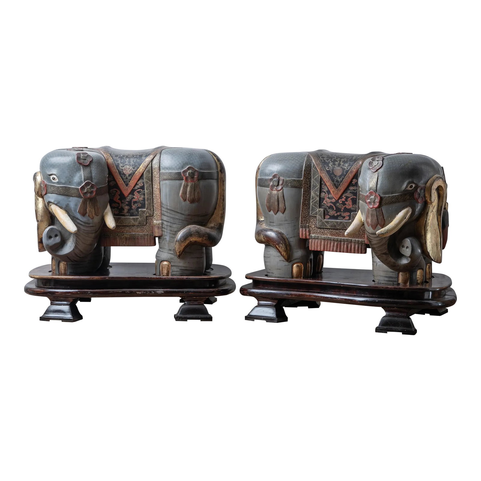 A Pair of Chinese Export Elephant Garden Stools: A pair of Chinese export elephant form garden stools, early 20th century. Carved wood with gilding and painting. On custom built plinths. Weighing over 100 pounds each. overall: 38 inches wide by 29
