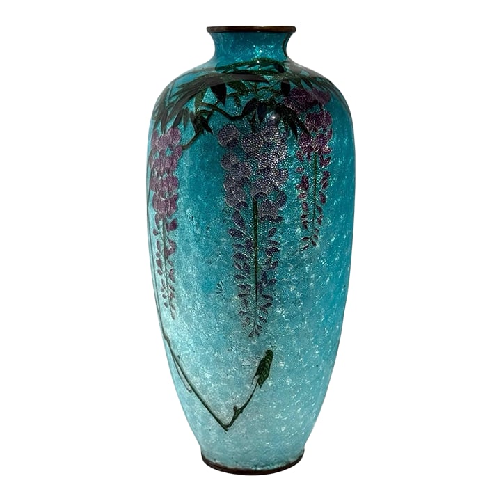 Japanese Cloisonne Enamel Vase Wisteria Ice Blue Ground 7 in Antique Meiji Era: A beautiful antique Japanese cloisonné enamel vase measuring 7 inches tall. The vase features cascading wisteria blossoms in shades of purple and lavender with delicate green leaves, all set