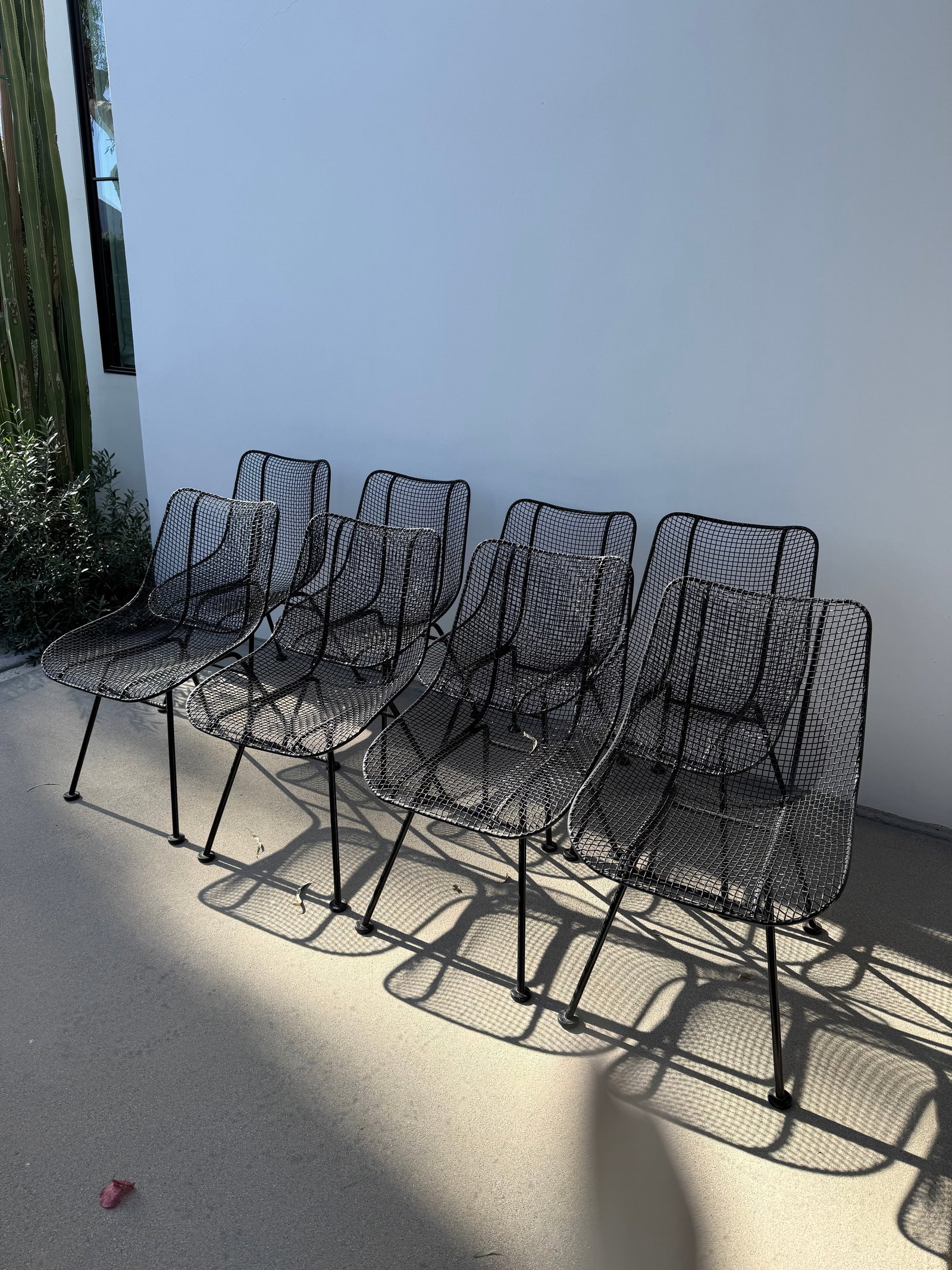 1950s Attributed to Russell Woodard Sculptura Metal Dining Chairs, 8 Pieces: Set of eight (8) unmarked, classic MCM wrought iron outdoor dining chairs that have been painted black from white. Condition: Alterations: Original Design Modified Imperfections: Some Imperfections