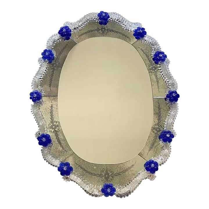 Hand-Carved Venetian Oval Mirror in Murano Glass Style, Early 21st Century: Spectacular oval mirror with Murano glass transparent elements and blue flowers. Oval mirror with venetian hand-carved floreal design, fruit of very hight italian craftamnship. A luxury piece of art f