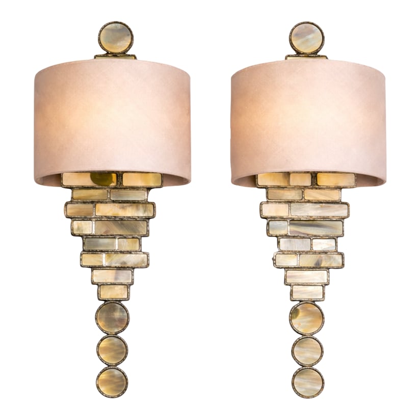 Vaughan Capiz Shell & Antique Pewter Wall Sconces – Pair | 25" H: Elegant pair of Vaughan wall sconces featuring stacked capiz shell panels framed in antiqued pewter metal, topped with tailored drum shades. The stepped architectural silhouette is accented with