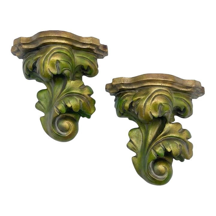 Vintage Palm Beach Regency Bespoke Parcel Gilt Green Brackets Newly Painted - A Pair: Imagine a grand foyer in a 1920s Palm Beach estate, where the salty air of the Atlantic meets the storied opulence of a Tony Duquette ballroom. These monumental brackets are not merely accessories;