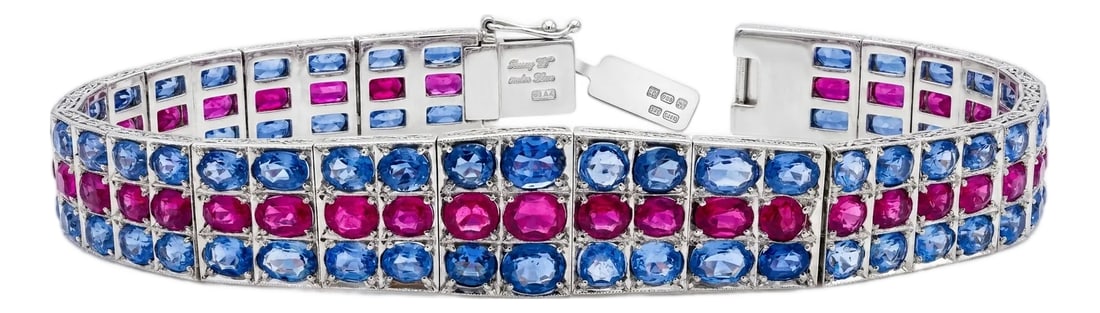 Natural Pink and Blue Sapphire Silver Tennis Bracelet: A striking wide-link tennis bracelet set in 925 sterling silver featuring 35 carats of natural oval-cut pink and blue sapphires arranged in three rows. The vivid pink sapphires form a bold center row