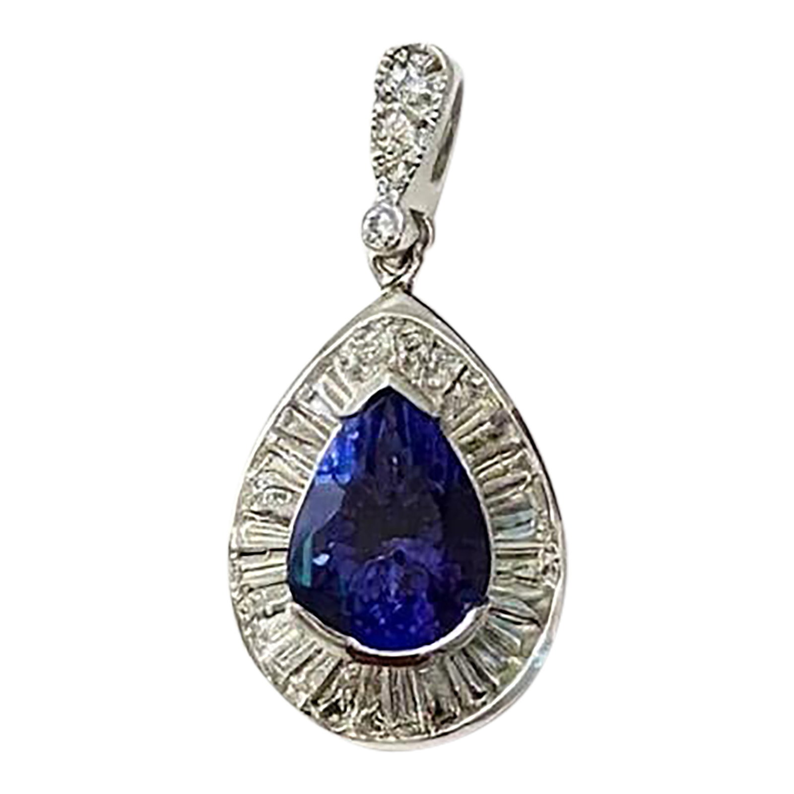 14k White Gold Pear Tanzanite Diamond Halo Pendant, 4.15 Ct Natural Tanzanite: A captivating 14K white gold pendant centered around a 4.15 carat natural pear-shaped tanzanite displaying a rich royal blue to violet-blue color. Surrounded by a halo of baguette diamonds with round