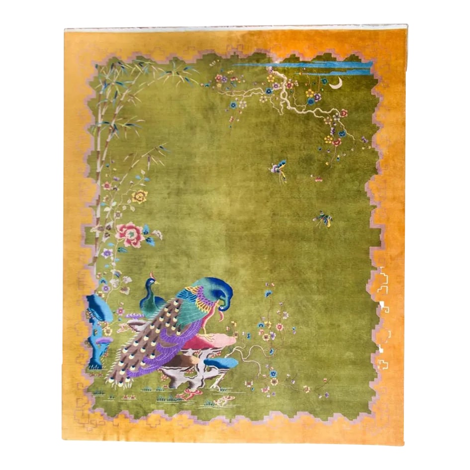 Early 20th Century Chinese Art Deco Rug: A remarkable early 20th century Chinese Art Deco rug with a brilliant chartreuse green field surrounded by a wide gold and lavender stylized cloud motif border. Two large peacocks live in one corner,