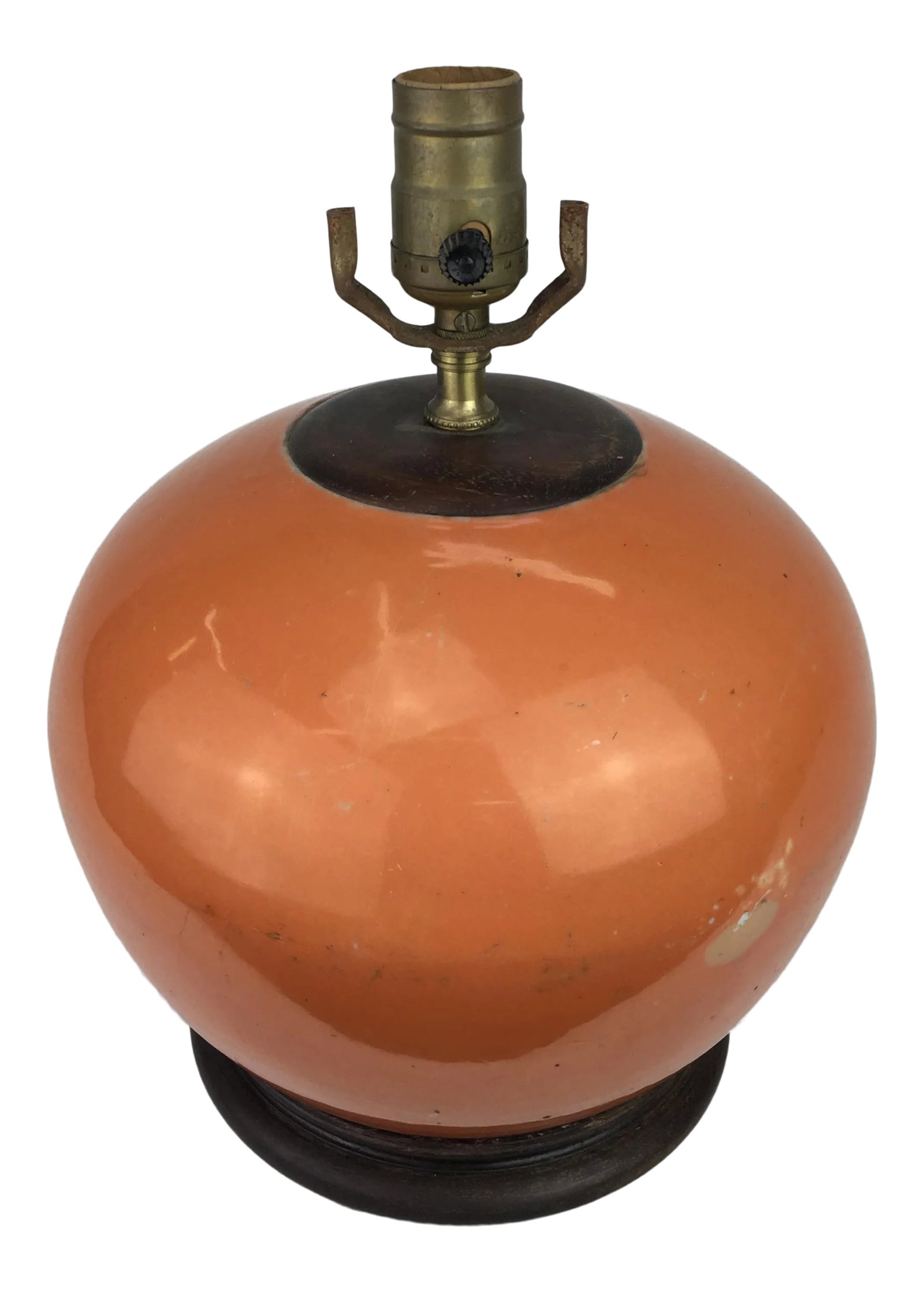 Vintage Mellon Jar Orange Porcelain Lamp: This rounded lamp has a lovely rounded shape grounded on a sturdy wood base and fired with a beautiful subdued orange hue. Has a big crack in one side. Condition: Alterations: Original Condition