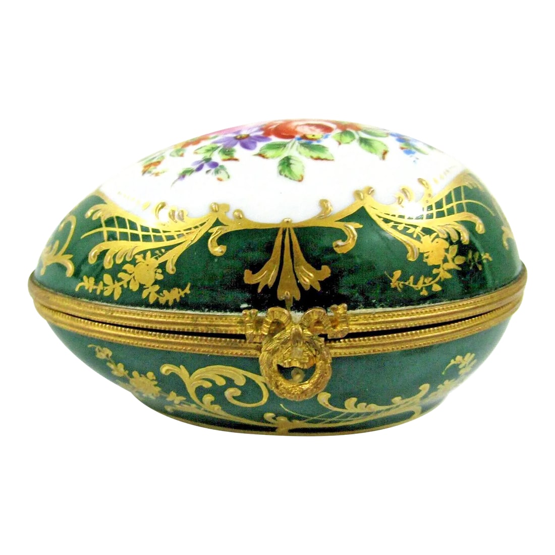 1950s Le Tallec Porcelain Egg Shaped Box with Flowers and Raised Gold Gilding: The egg-shaped box with green ground hand-painted with scrolls and oval filled with flowers, the interior is floral-painted, the rims with ormolu bands and wreath-form closer. Measures 4" long, 2 3/8"