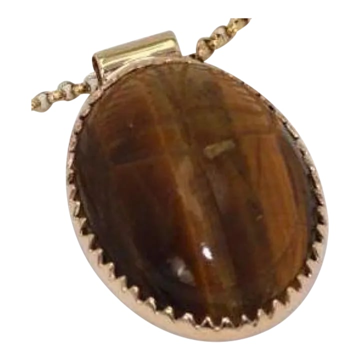 Vintage 18k Tiger's Eye Scarab Pendant: This is part of Chairish's Fine Jewelry assortment. METAL: 18k yellow god SIZE: 20mm x 26mm WEIGHT: 6.2 grams CONDITION: Vintage Vintage 18K Tiger's Eye Scarab Pendant. Gorgeous vintage tigers eye