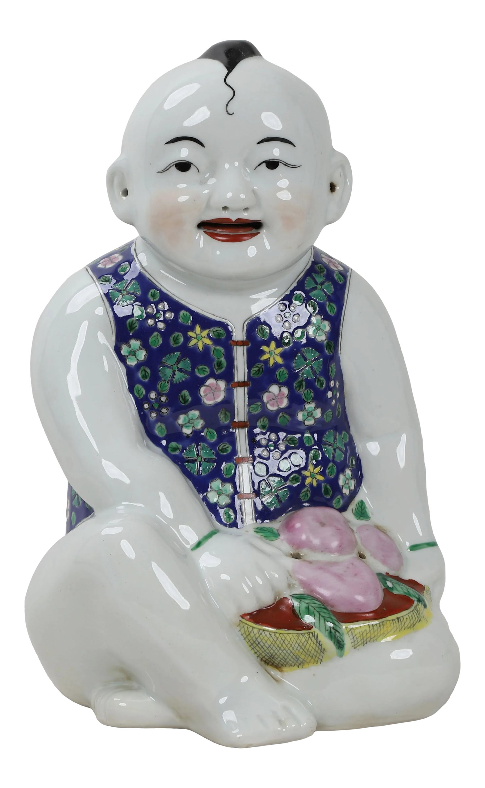 Early 20th Century Porcelain Blue & White Figurine: Porcelain blue & white figurine in sitting position. Garbed in an embroidered tunic hand painted with flowers and leaves, a small pile of buns or peaches sit on a pillow in his lap. This Vintage