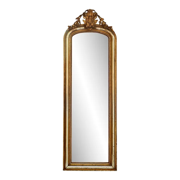 Exceptional 19th Century French Wall Mirror: A magnificent late 19th century French, Louis XV style gilt overmantel mirror, in wood and gilded stucco, with string-of-pearls beading to the interior perimeter. This beautiful mirror features a