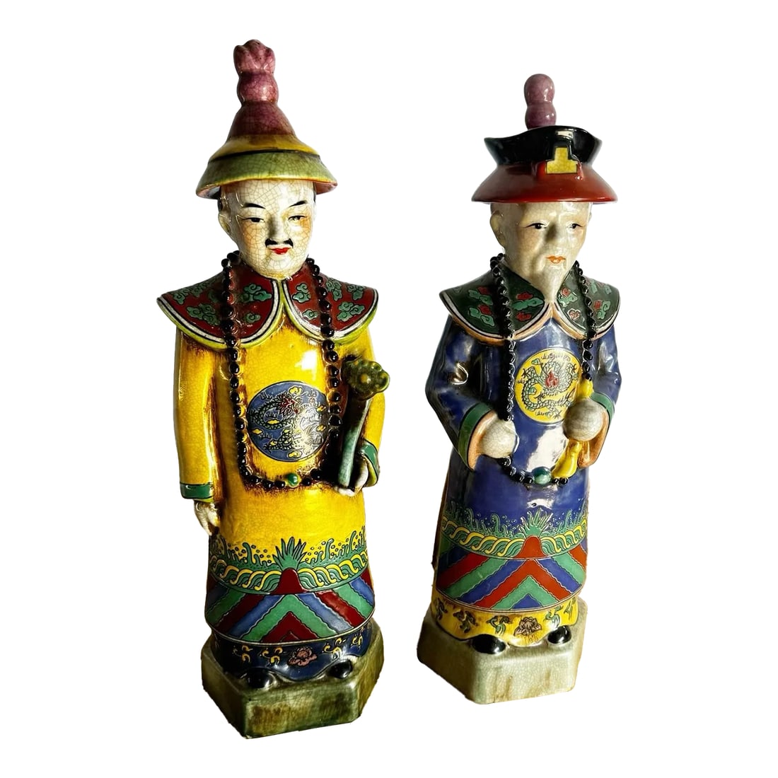 Chinese Hand Painted Porcelain Emperor Sculptures - 2 Pieces: This pair of Chinese hand-painted porcelain Emperor sculptures radiates elegance and cultural richness. Featuring vibrant traditional attire with intricate detailing, each figure is adorned with