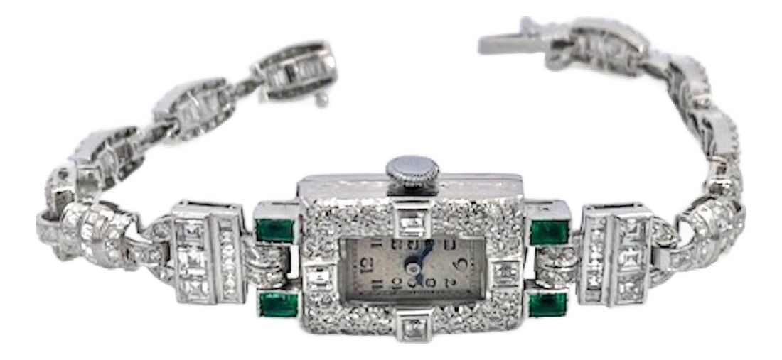 1930s Deco Diamond Emerald Ladies Wristwatch: This wristwatch is special as it is all Diamonds with 4 square Emerald stones each .20 to total .80 carats the balance is Diamonds in round cuts, baguette cuts. There is approximately 3 carats of
