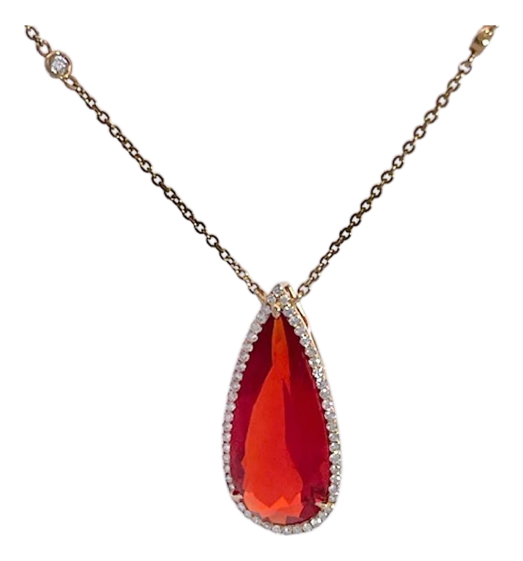 Fire Opal With Diamond Surround 18k: This Fire Opal pendant is rare because it is faceted. Most Fire Opal are Cabochon cut not faceted.. Also Fire Opal are only found in Mexico, I found some in Cabo but this one comes out of the U.K. Thi