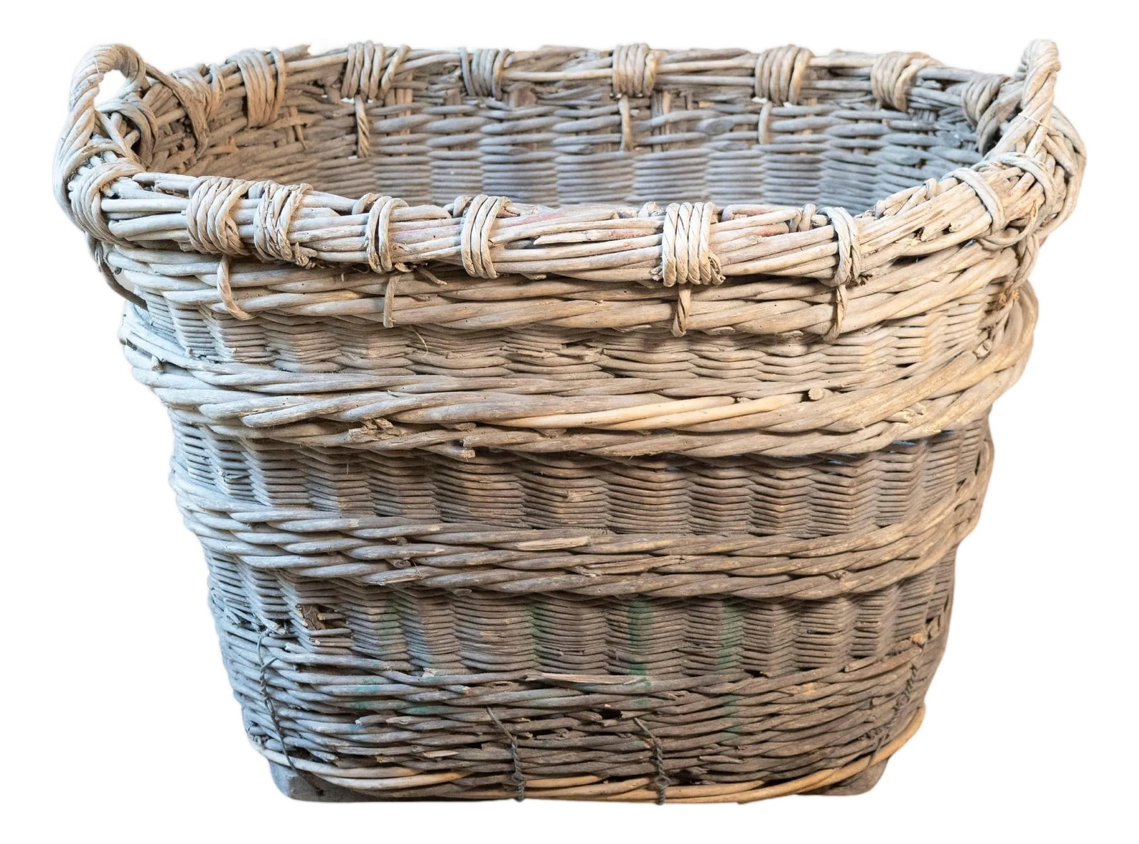 Early 20th Century French Wicker Grape Harvesting Basket: A charming and sculptural mid-20th-century French wicker grape harvesting basket, sourced from the vineyards of the Champagne region. Crafted entirely by hand, this basket was used during the autumn