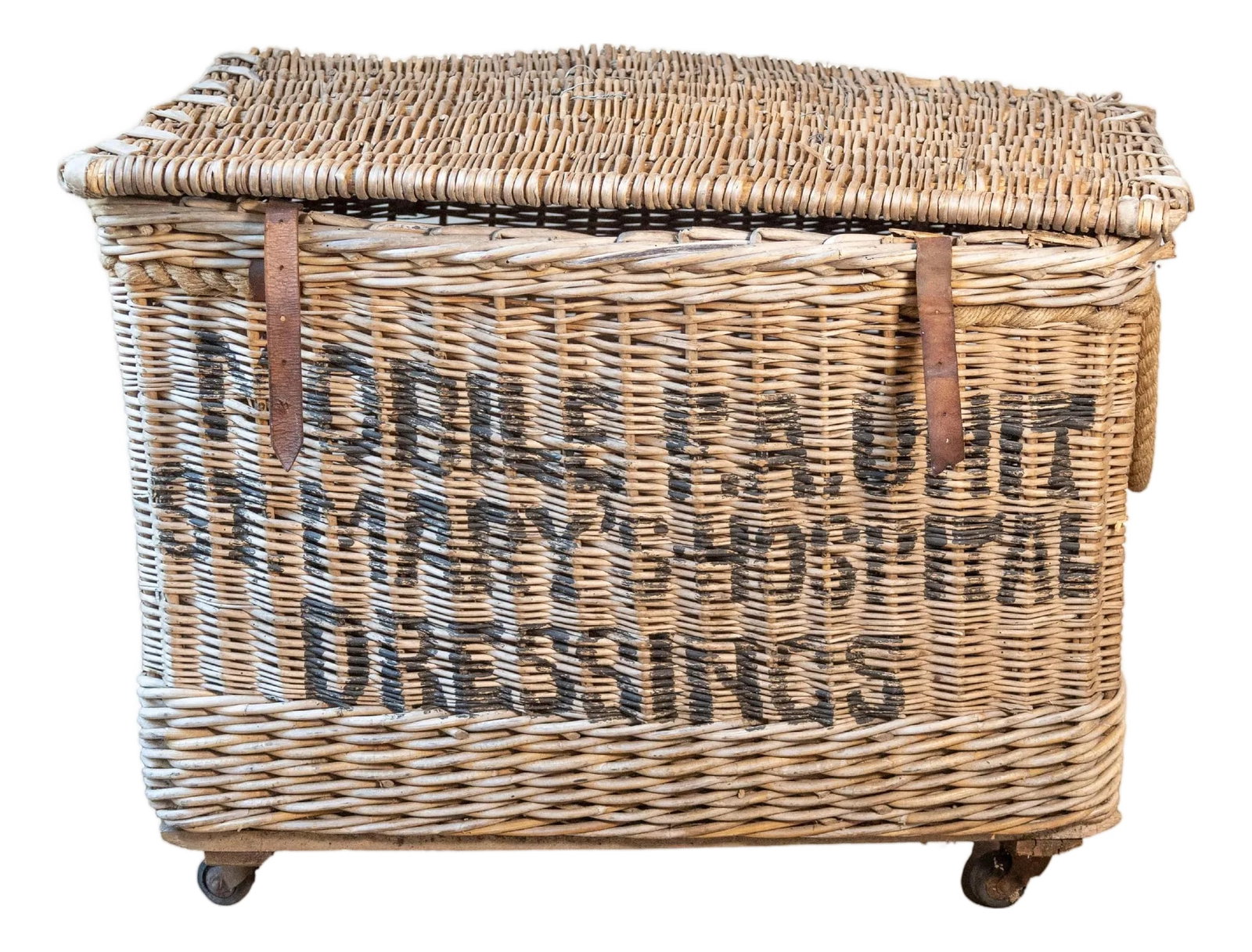 Early 20th Century English Wicker Laundry Basket on Wheels with Stenciled Labeli: A large and characterful English wicker laundry basket dating to the early 20th century, featuring original cast iron wheels and handwoven willow construction. The front is boldly stenciled with