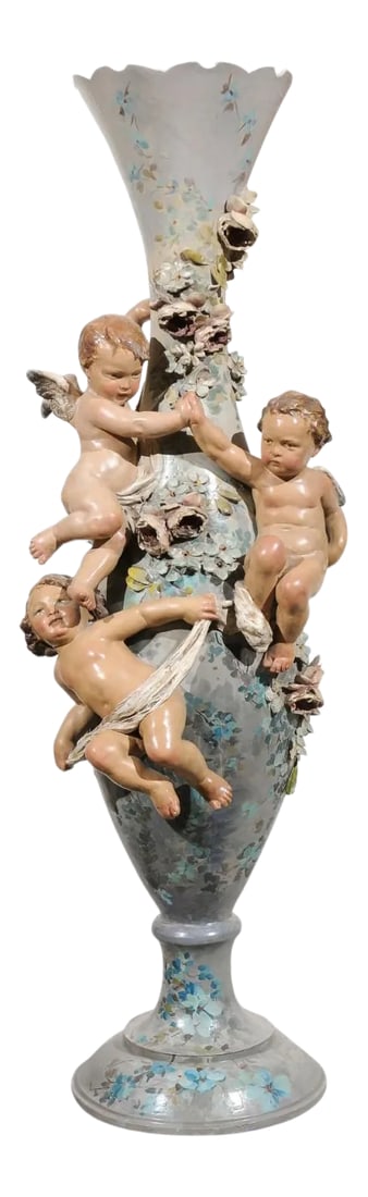 French 1870s Slender Majolica Vase with Floral Décor and High-Relief Cherubs: A French Majolica vase from the second half of the 19th century, with cherubs and floral décor. Born at the end of France's last Emperor Napoleon III's reign, this exquisite vase features a soft
