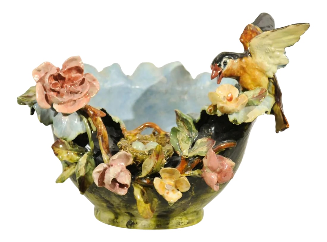 19th Century French Barbotine Covered Bowl with Bird and Bird Nest Décor: A 19th century petite French faience bowl adorned with a bird and bird nest barbotine décor. This French pottery features a green colored body, decorated with exquisite colorful flowers. A small