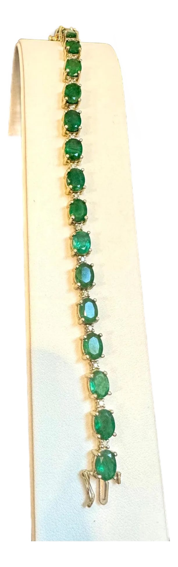 22 Carat Natural Brazilian Emerald & Diamond Tennis Bracelet 14 Kt Yellow Gold: This exceptionally affordable Tennis bracelet has 19 stones of oval Emeralds . Each Emerald is spaced by two diamonds . Total weight of the Emeralds is approximately 15 carat. Total number of