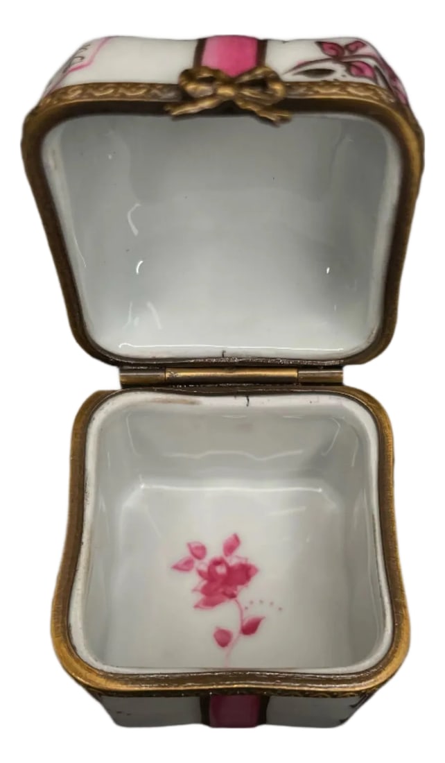 Early 20th Century Limoges Pink Bow Box: 1.6" Wide 3/4" Tall Add a touch of elegance and femininity to your home decor with our Limoge Pink Bow Box. Perfect for storing small items and displaying as a decorative piece. Its delicate design an