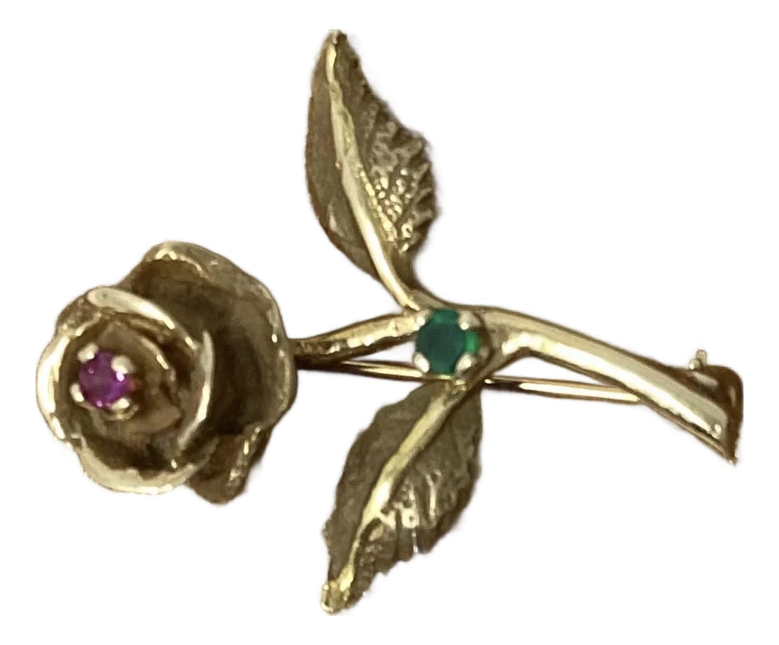 14k Gold Pin in Shape of Long Stemmed Rose With Ruby and Emerald Accent: Beautifully detailed pin in the shape of a long stemmed rose accented with a ruby center and emerald on the stem. Stamped 14k on back on leaf Condition: Alterations: Original Condition Unaltered