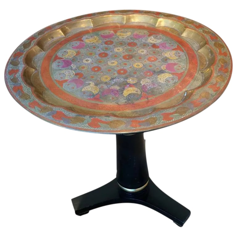 Regency Style Enameled Brass Top Side Table: Rich looking side or drinks table having an ebonized pedestal with giltwood rings, resting on tripod legs, topped off with a stunning enameled brass top with Indian pattern in burnt orange, fuschia,