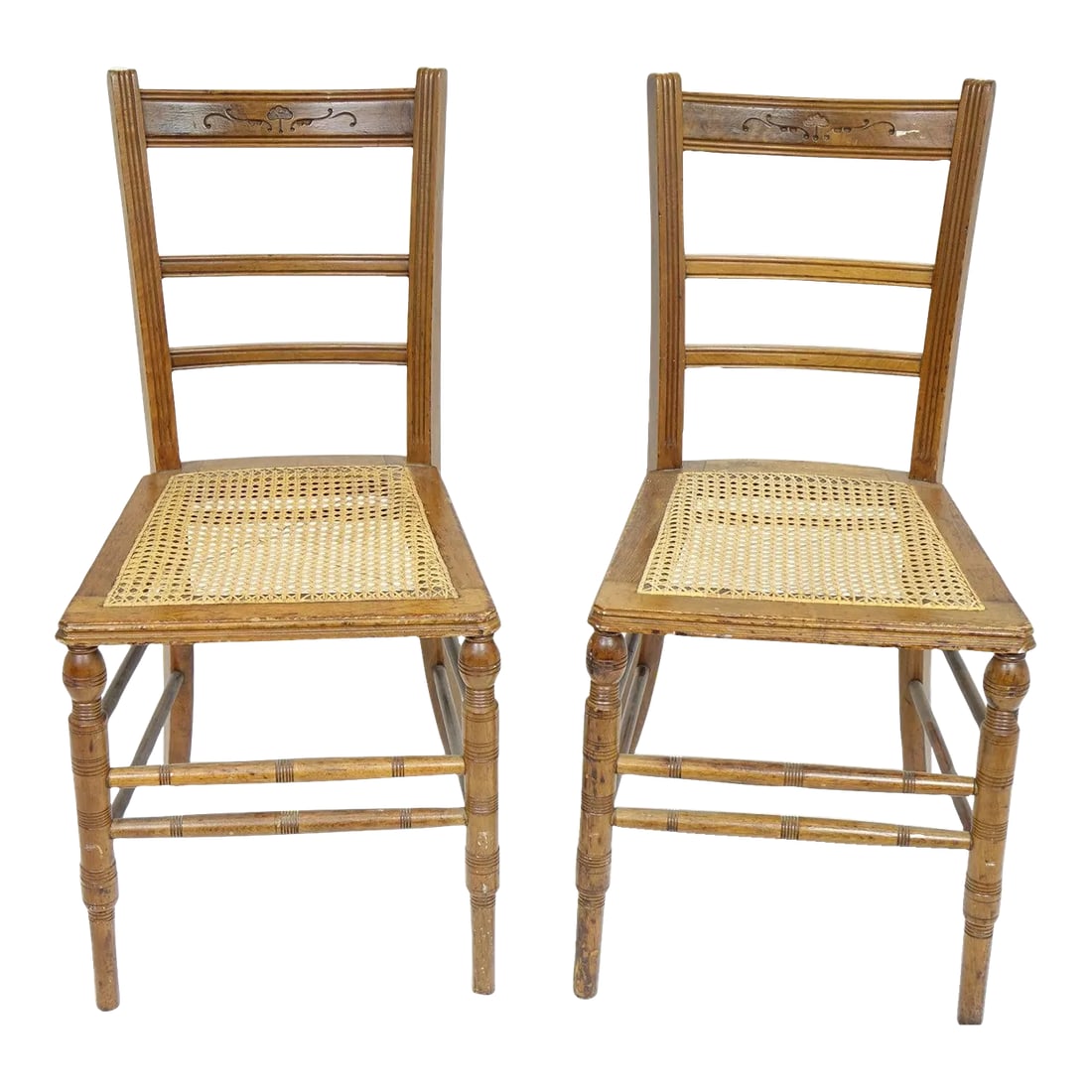 Vintage Chairs With Woodwork - a Pair: This charming pair of vintage chairs showcases exceptional craftsmanship and timeless design. The elegantly tapered legs and intricately turned spindles highlight the skilled woodwork, while the natur