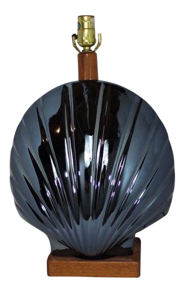 1950s Vintage Art Deco Style Large Metallic Blue Shell Table Lamp: We hope you enjoy this Art Deco style metallic blue large clam shell table lamp. This lamp is made of porcelain with a metallic blue glaze and wood base and neck. There is no lampshade included.