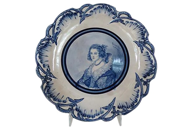 Antique Hand-Painted Staffordshire English Wall Plate: Elegant 19th-century English Staffordshire Empire Works hand-painted scalloped portrait plate. Great for wall display. Maker's mark on underside. Stand not included. Condition: enamel chip to rim