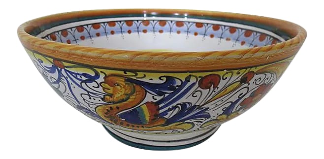Vintage Italian Faience "Deruta" Bowl: Italian Deruta faience centerpiece bowl with decorated interior and exterior in rich colors, using brilliant blues, yellow and red. Maker's mark on underside. Condition: Excellent Dims: 9.8" Dia x