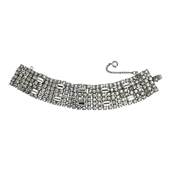 Vintage Weiss Clear Rhinestones Bracelet: This is part of Chairish's Costume Jewelry assortment. Glitzy vintage bracelet likely dating to the 1950s. It features 6 rows of clear rhinestones accented by 10 large baguettes. Setting is silver in