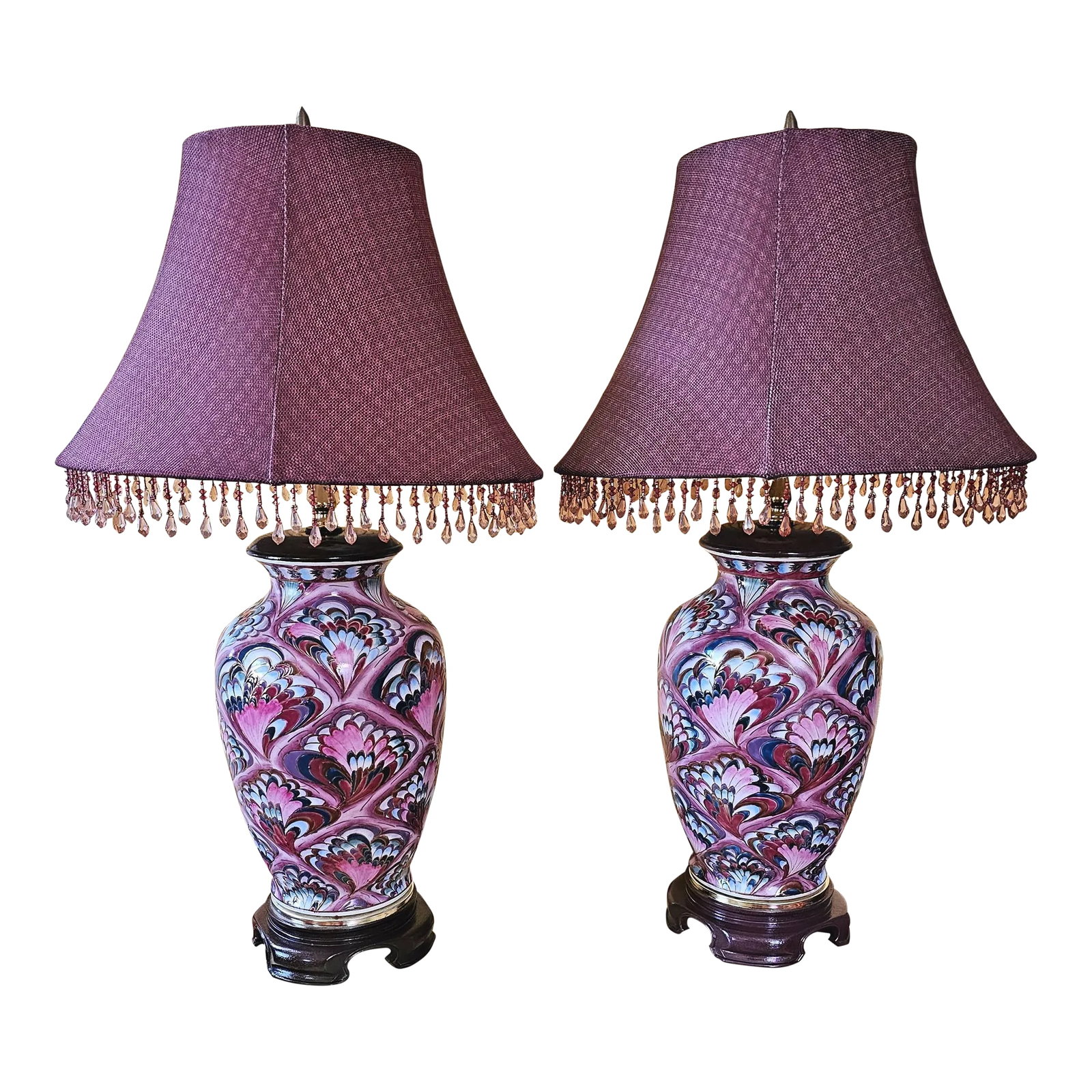 1990s Chinoiserie Pink Porcelain Peacock Ginger Jar Table Lamps With Shades - a Pair: This pair of exquisite Chinoiserie porcelain ginger jar table lamps feature pink, purple, light blue and dark green colored peacock feathers with gold accents. They sit on resin bases and come with